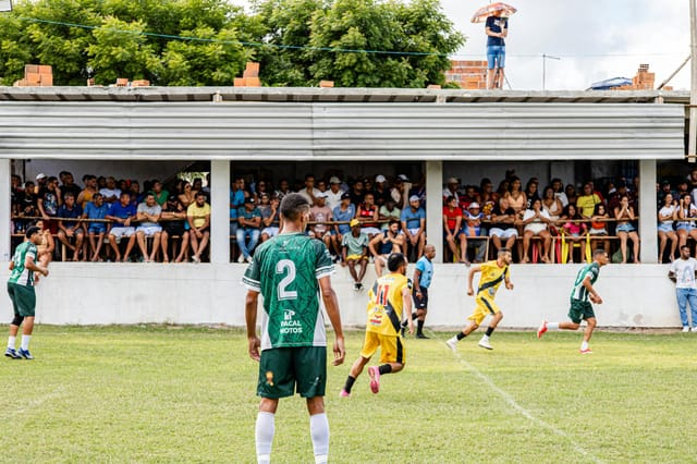 Football match with enthusiastic crowd watching from the stands